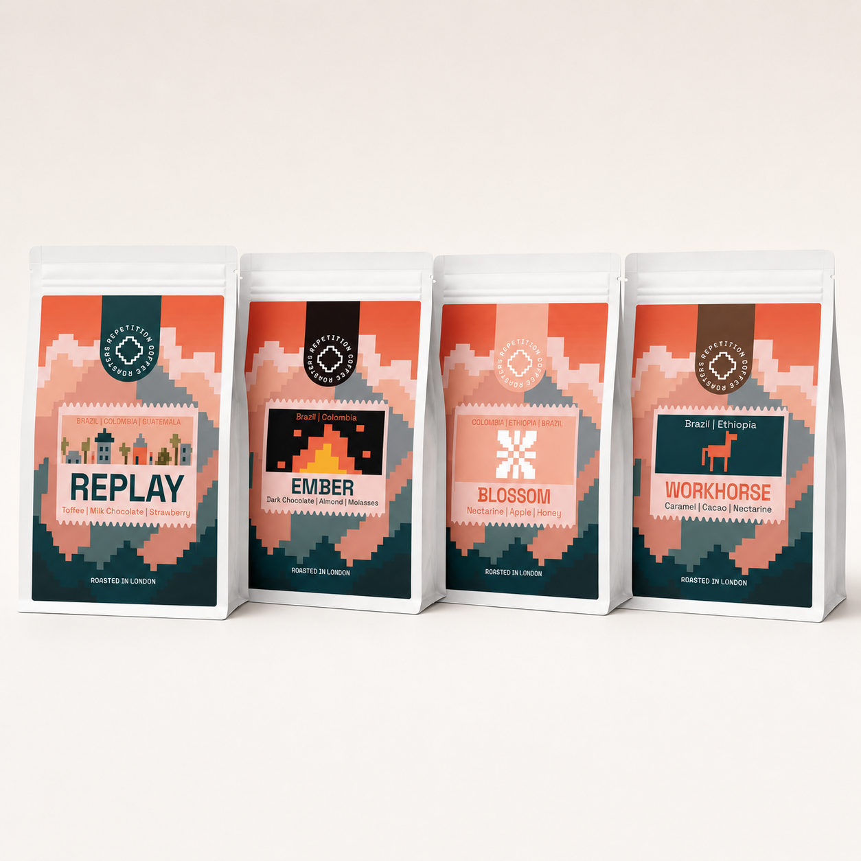 Four 250g bags of Repetition coffee side by side: Replay, Ember, Blossom and Workhorse